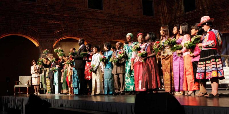 A long row of laureates on stage. 