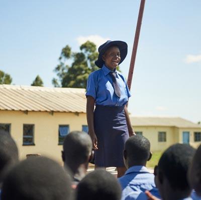 Girl speaking to other children