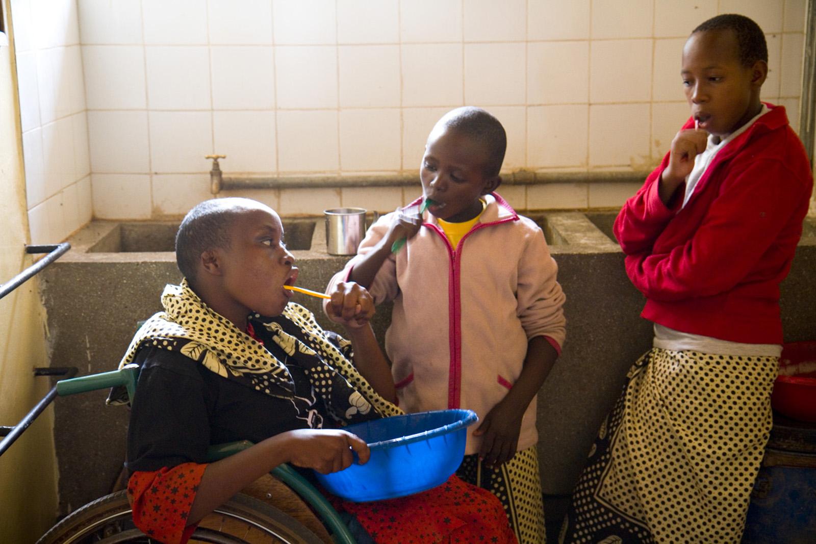 three boys brushing their teeth