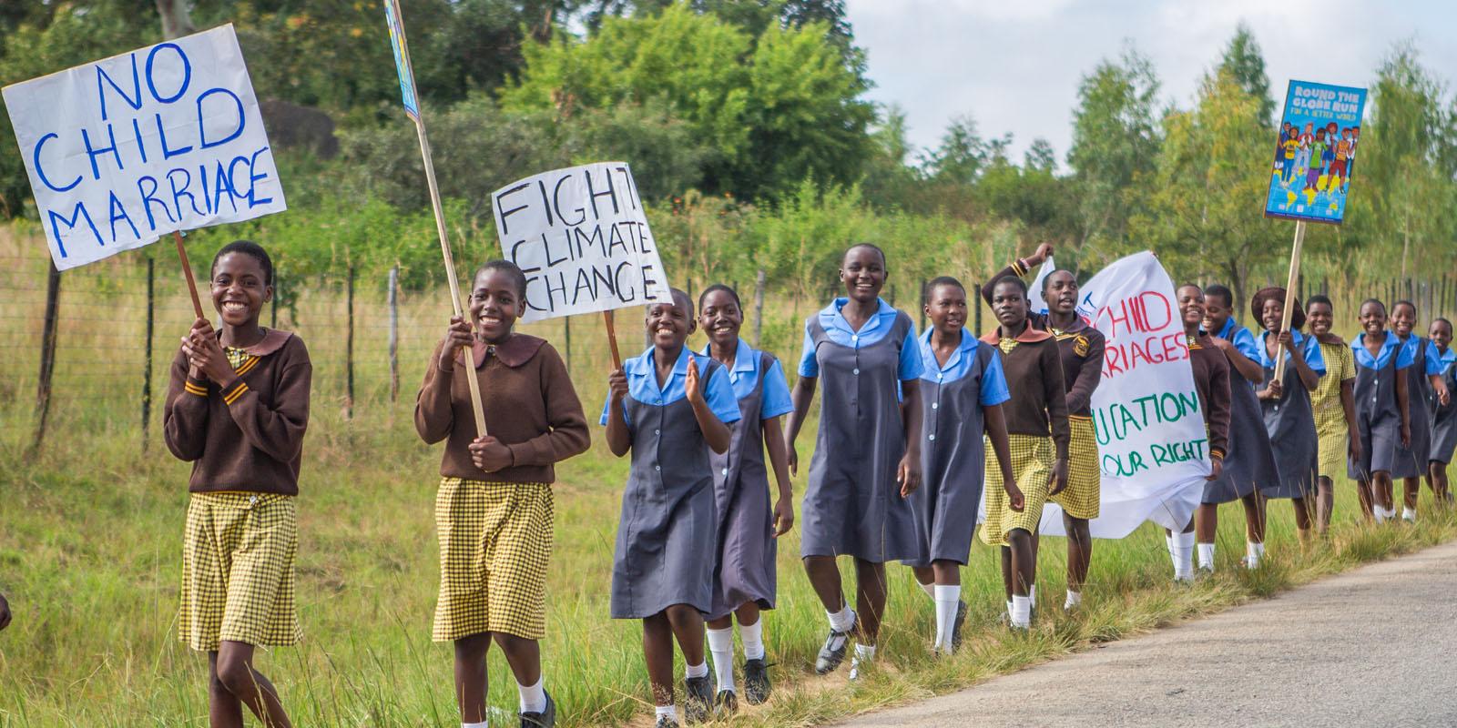 Children in line holding signs