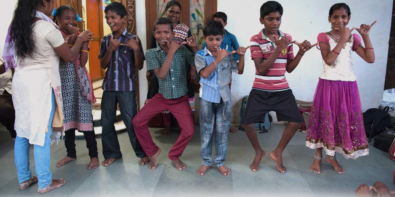 Children in a line, playing, looking happy