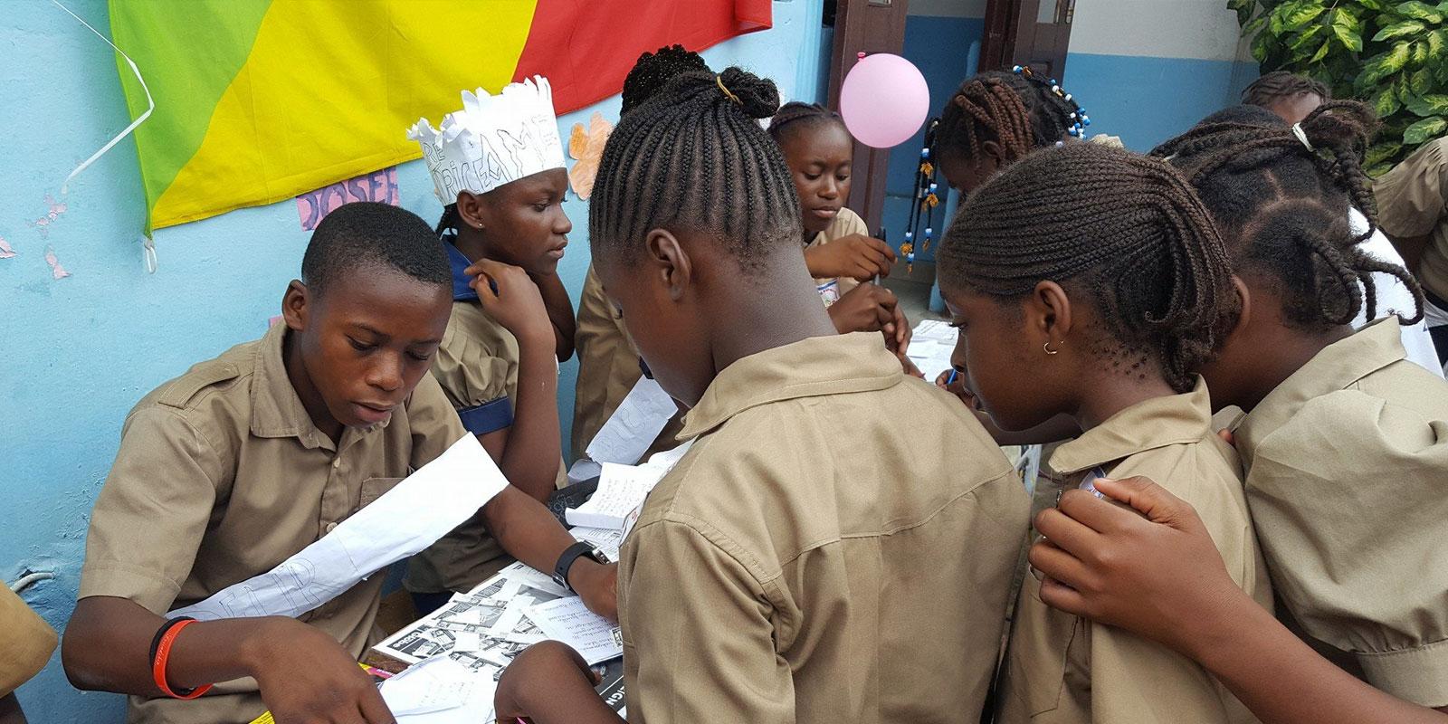 Boy checking girls names on voting register.