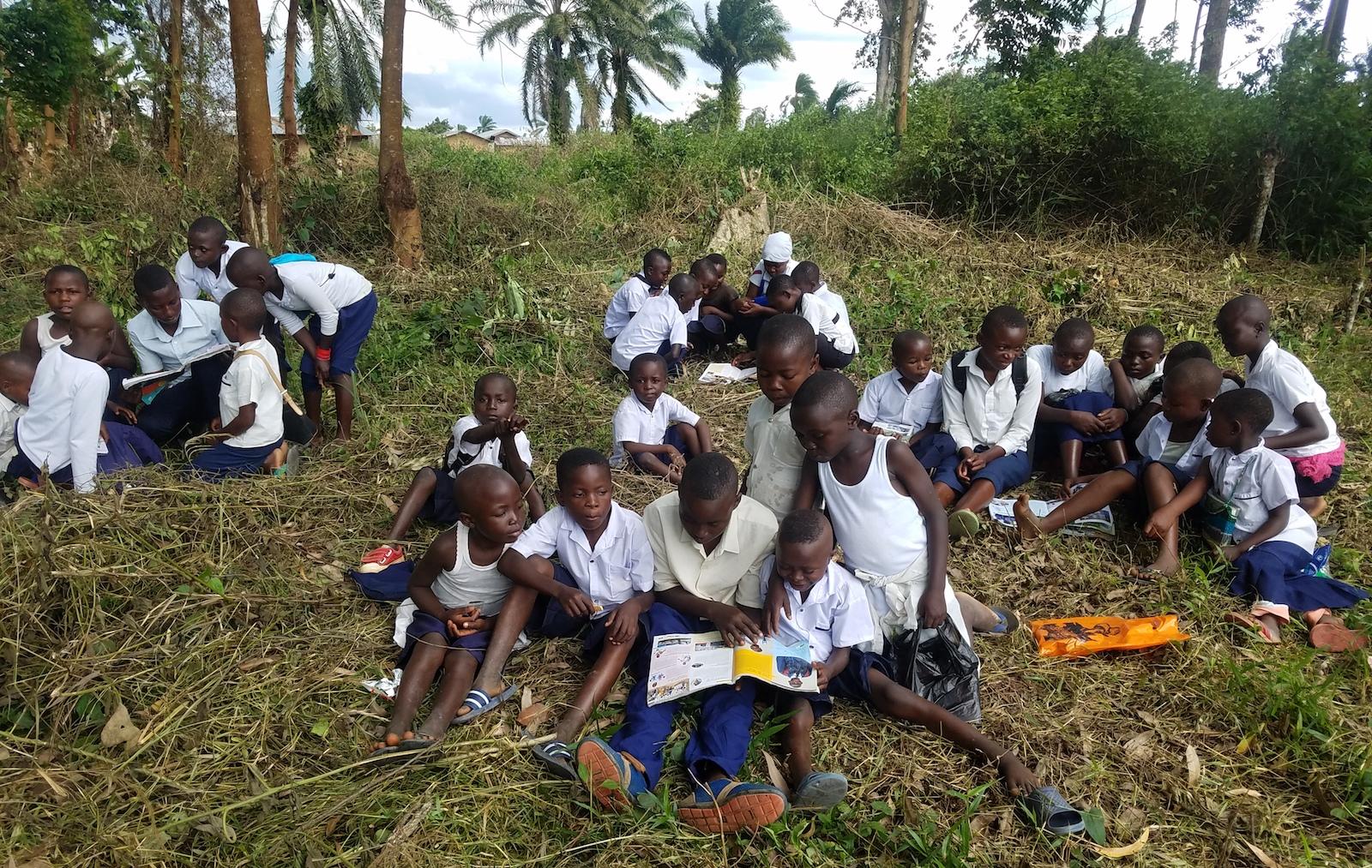 Children studying the Globe outside