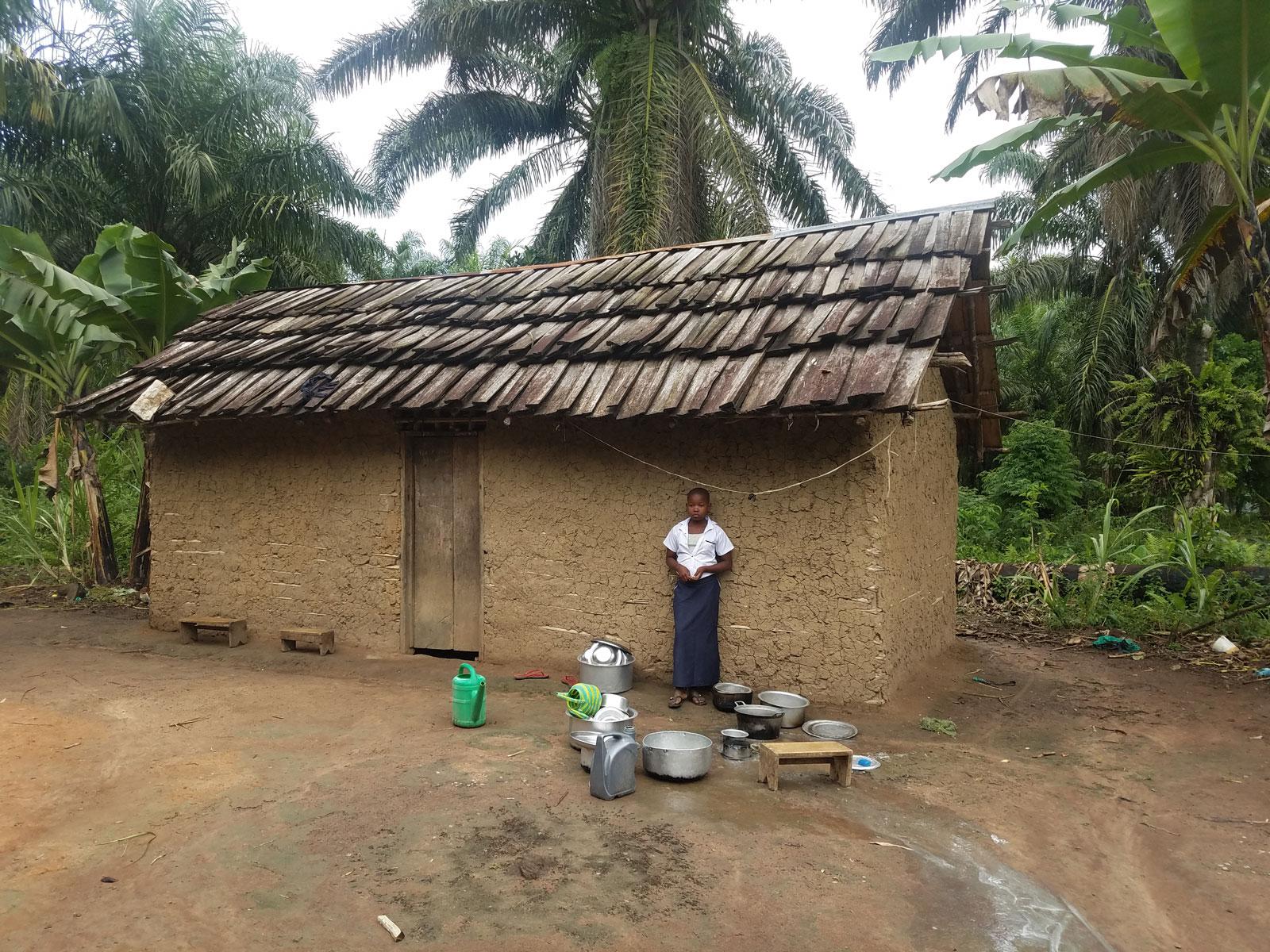 Eugenie standing outside her house