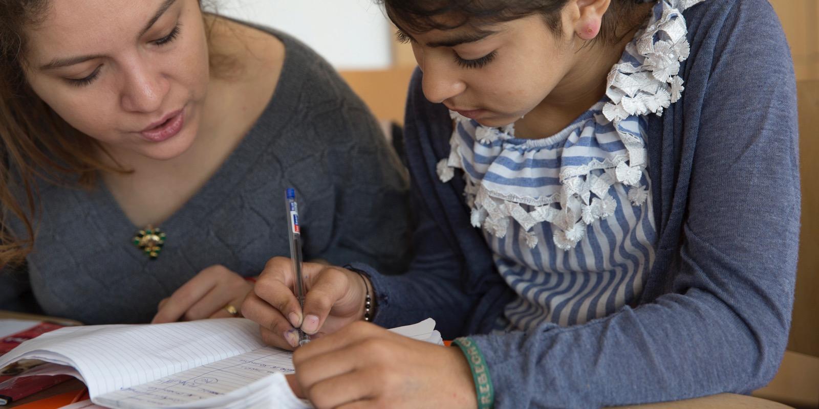 Tutor and girl working together