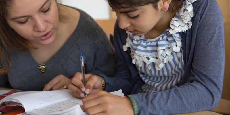 Tutor and girl working together