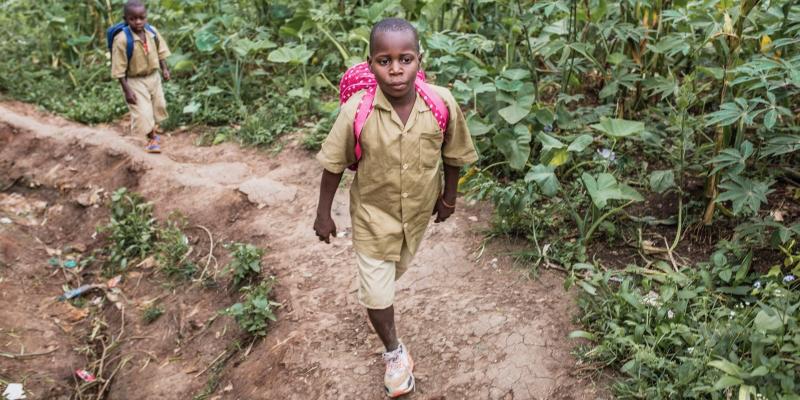A picture of a child walking outside. 