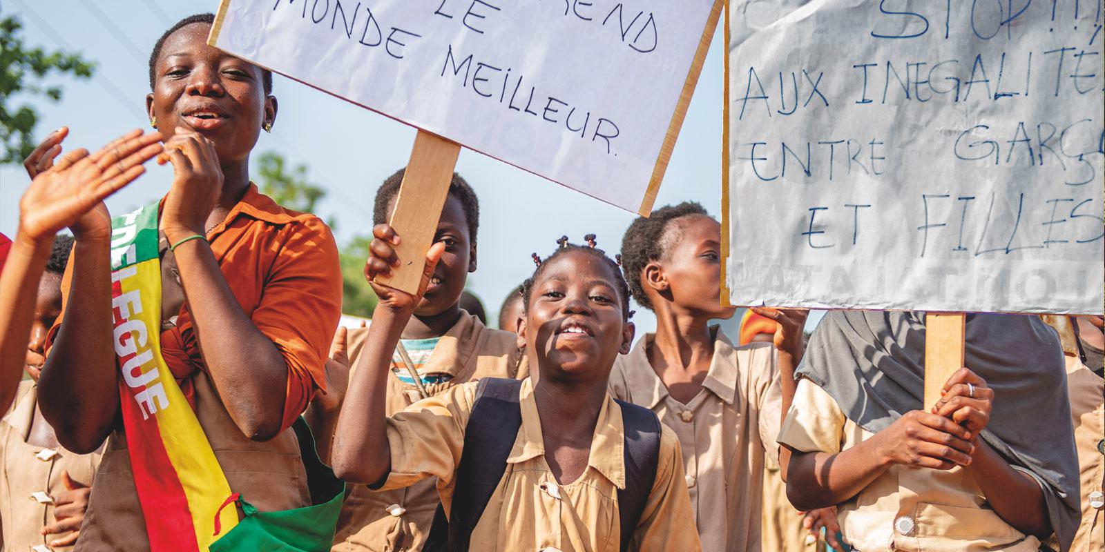 Happy smiling girls rallying with signs.