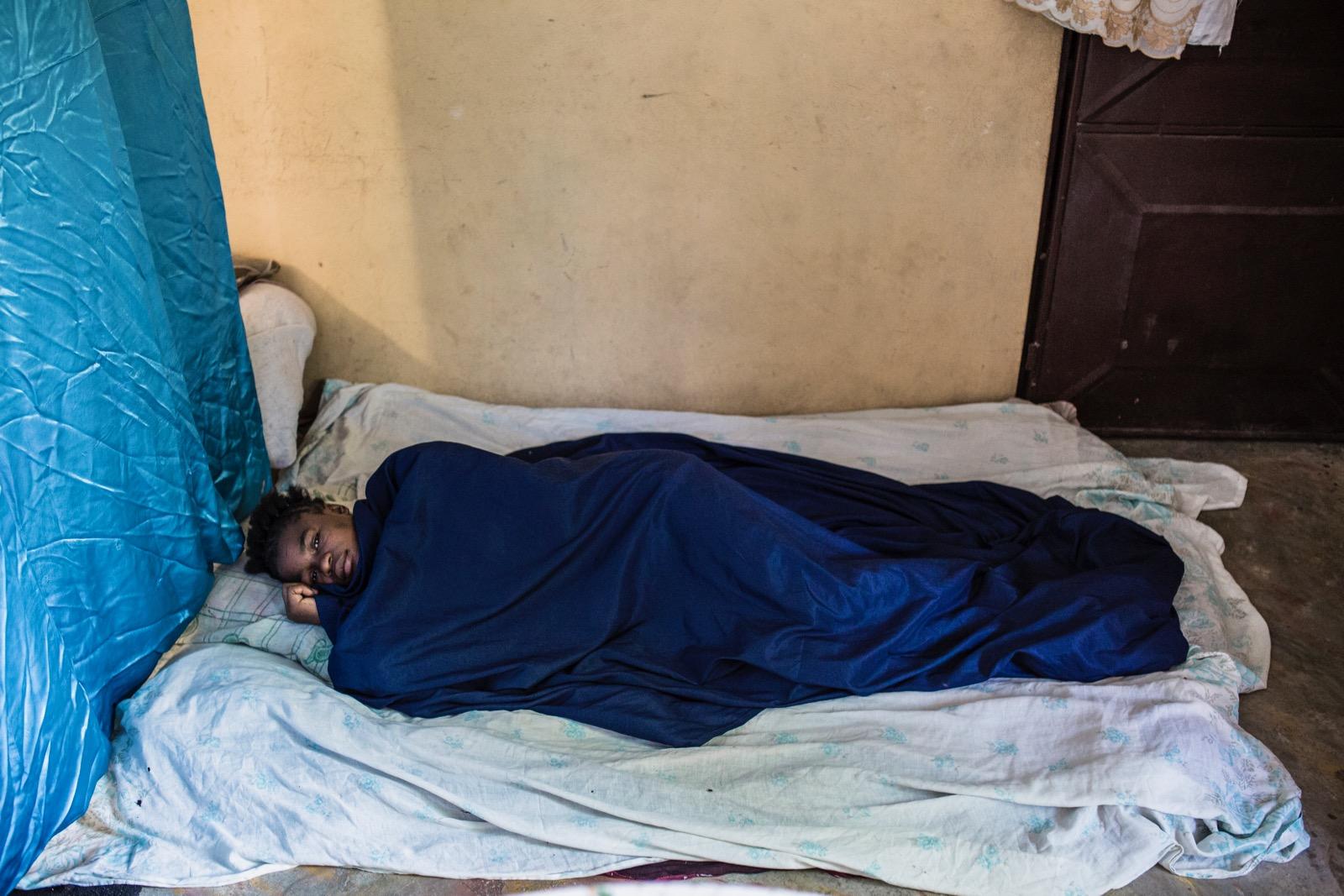 A girl sleeping on a mattress.