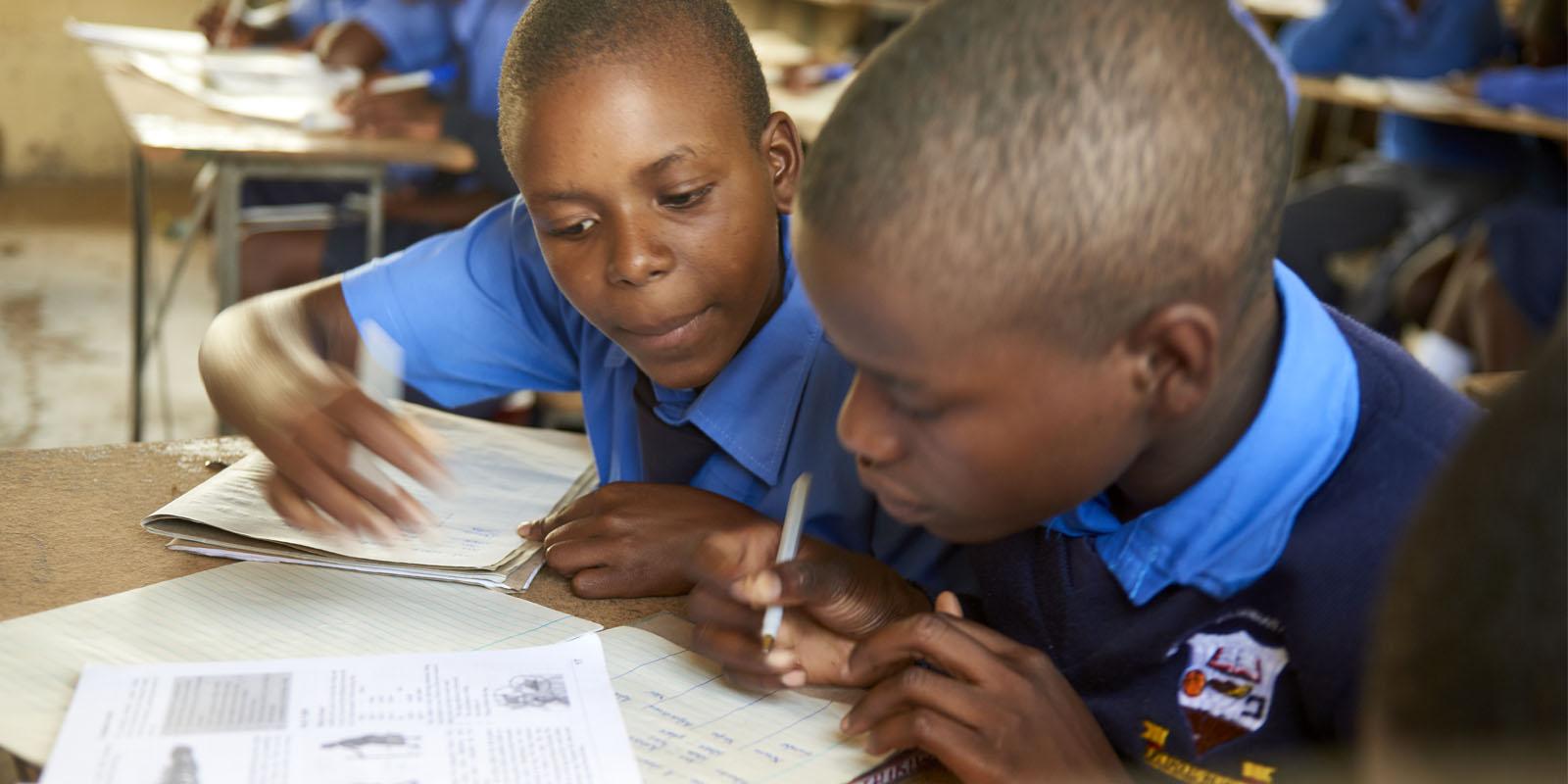Kids helping each other in a classroom