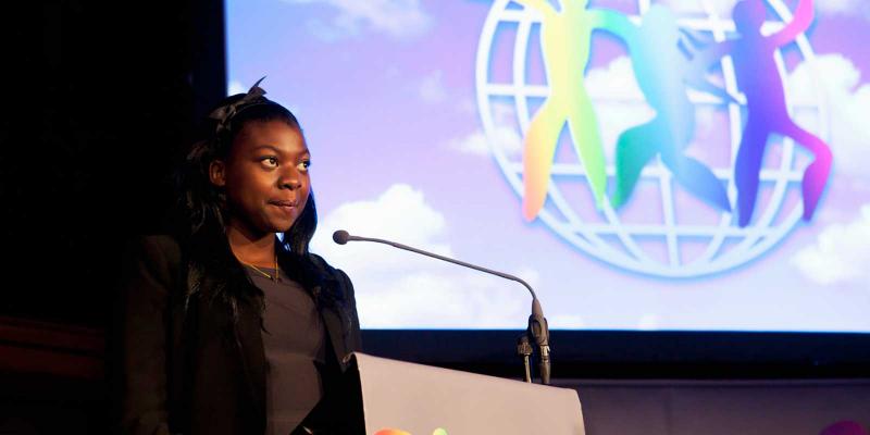 Lisa on the podium in front of WCP logo