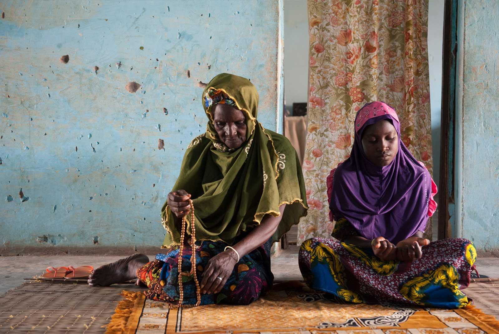 Woman and girl sit on floor