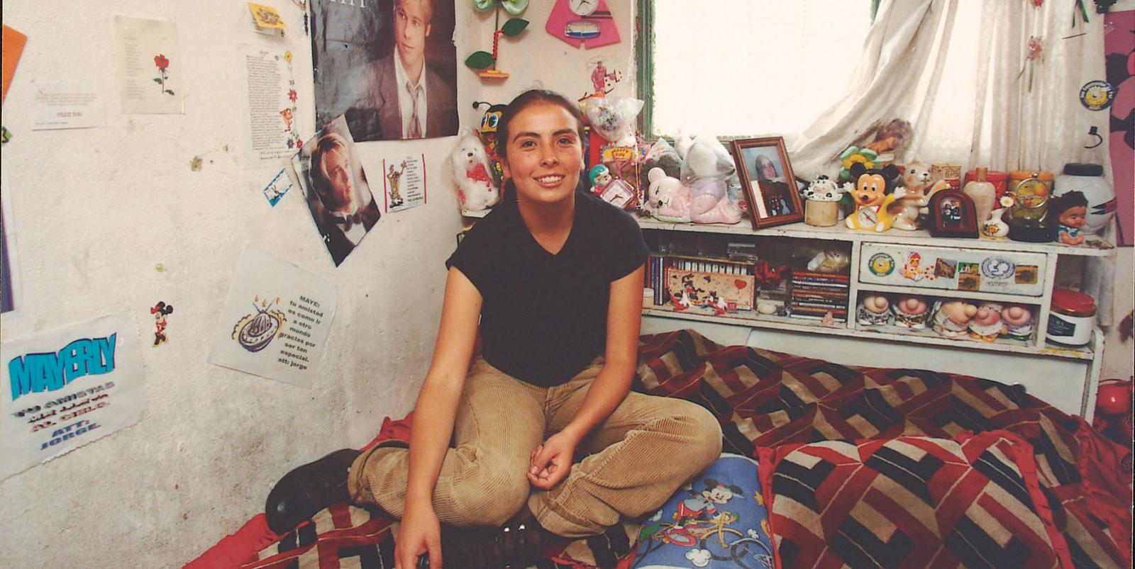 Mayerly sits on her bed