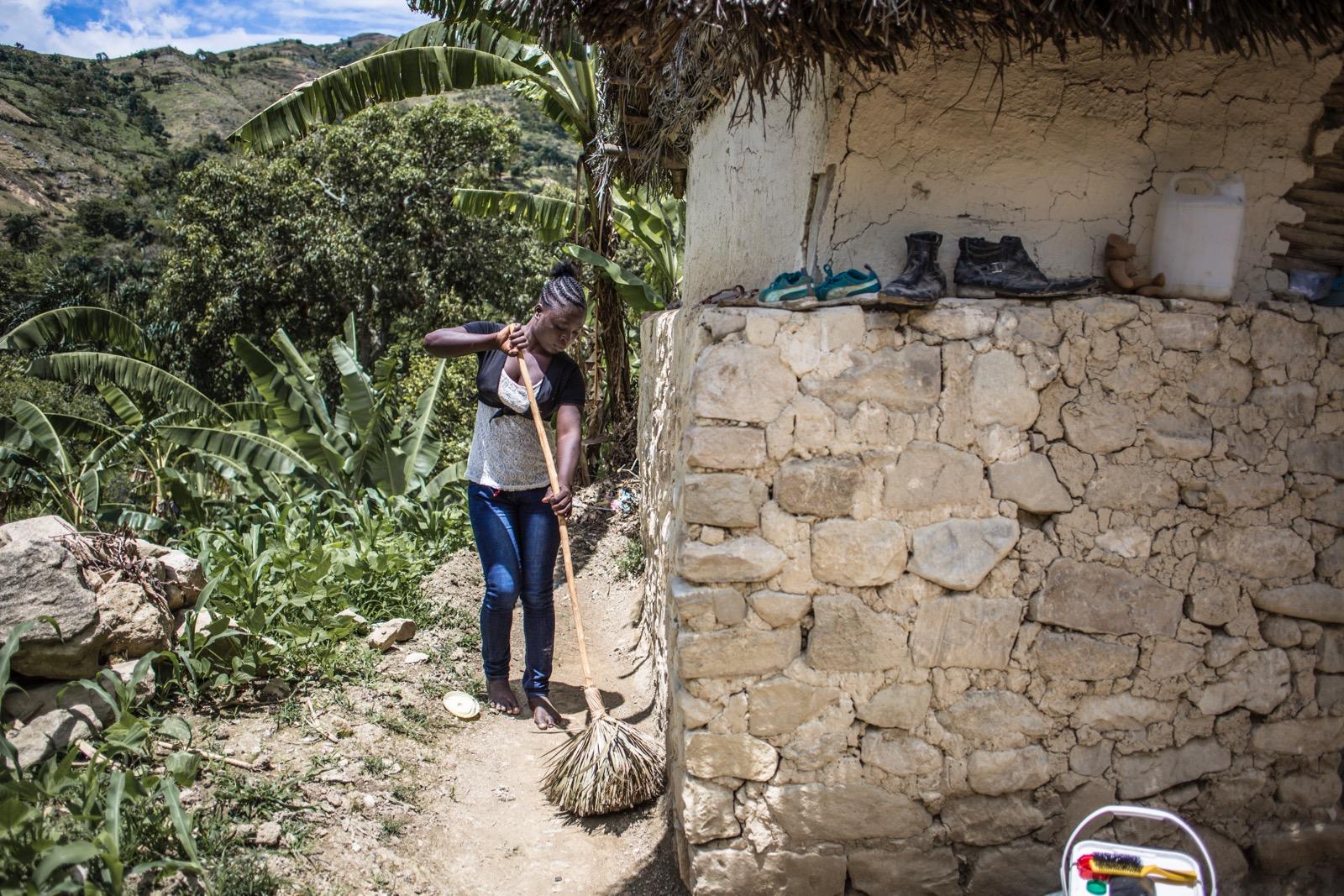 A girl sweeping the ground.