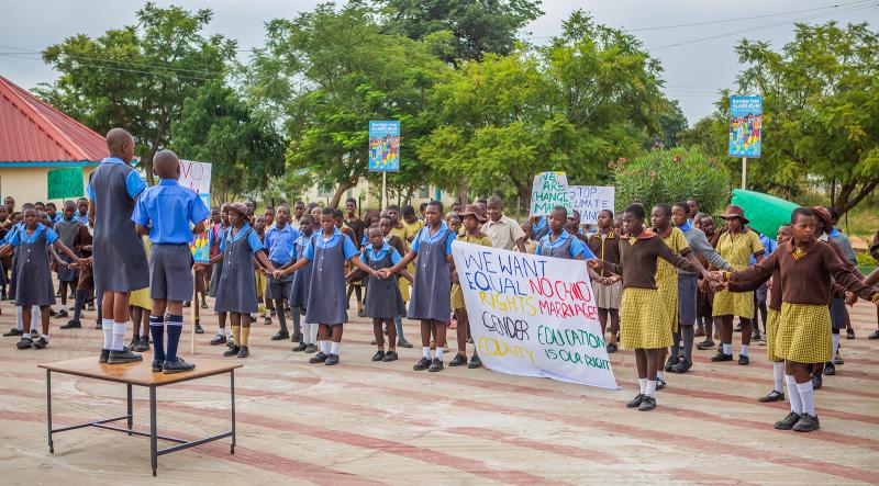 Children demonstrationg for child rights in school yard