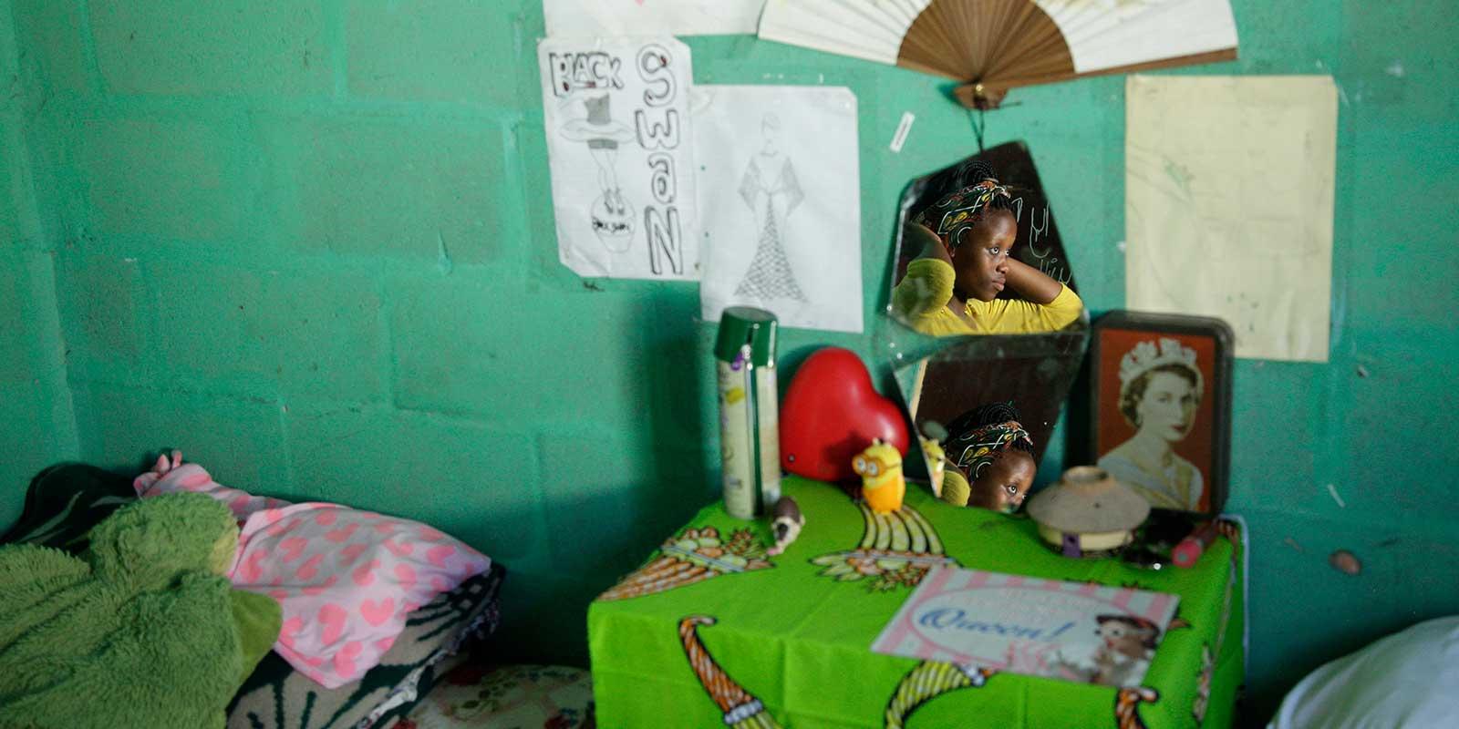 Sam looking in the mirror in her room