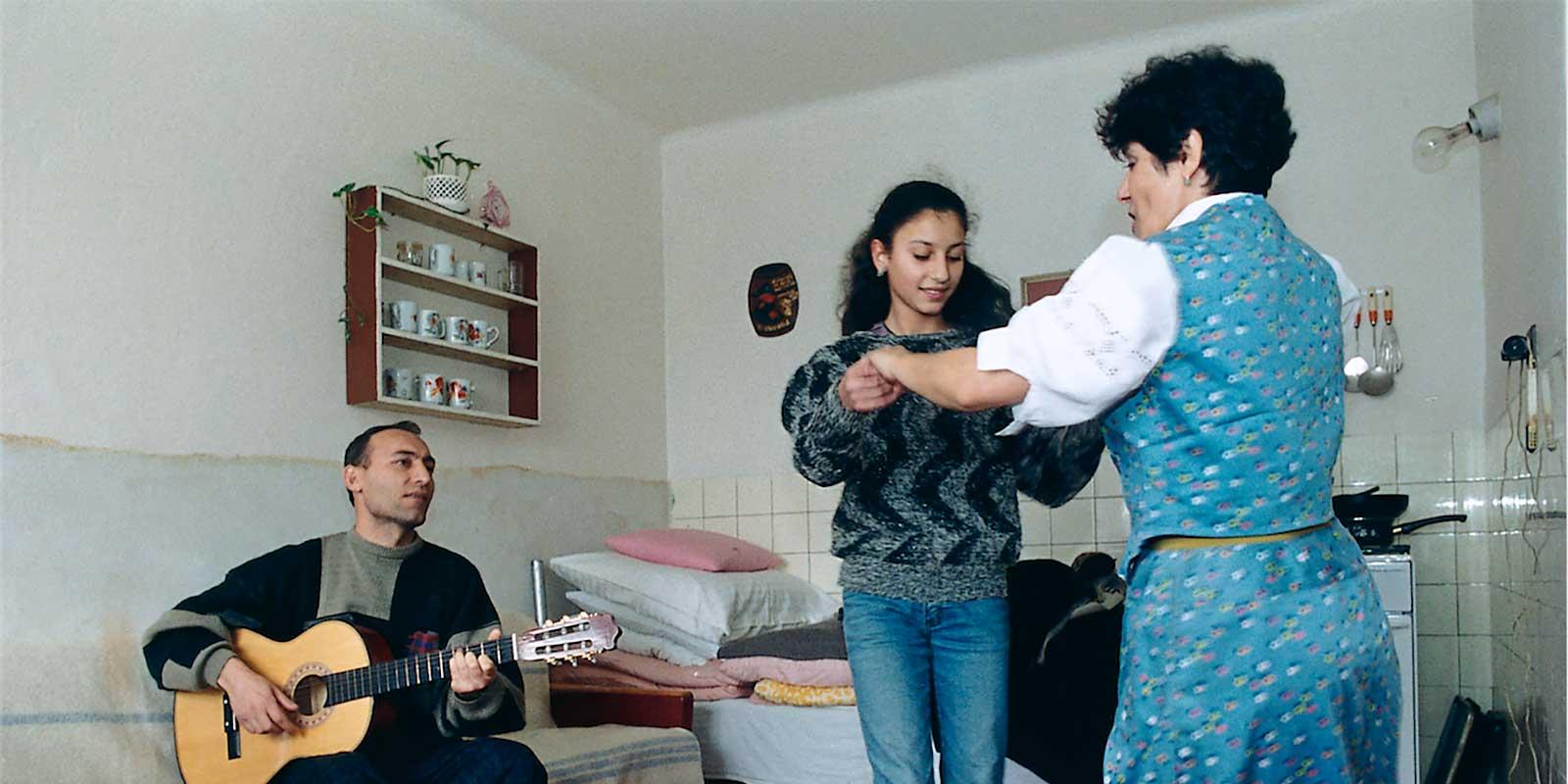 Svetlana dancing with her mother while her father playing guitar
