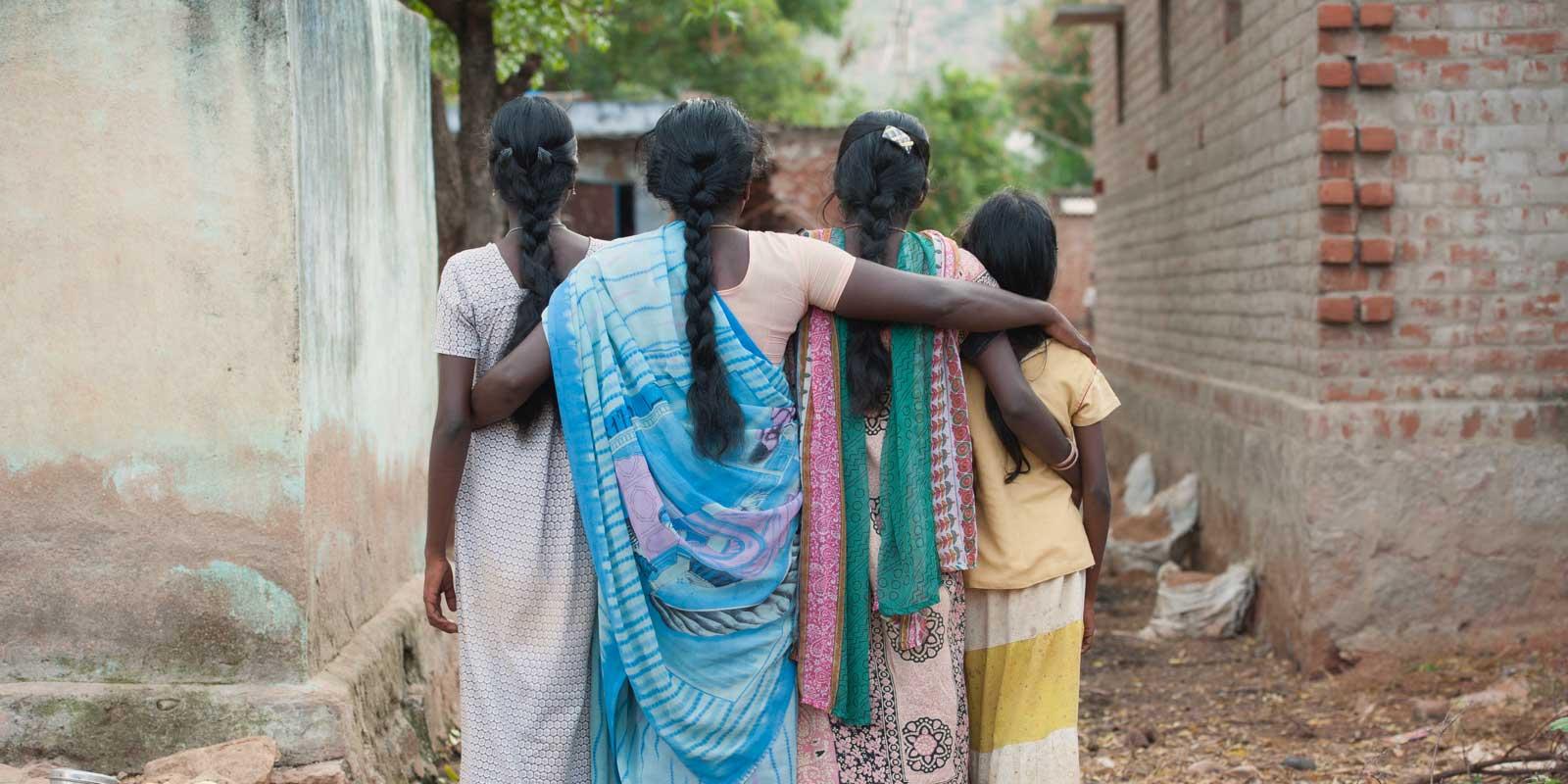 Mother and three daughters seen from behind