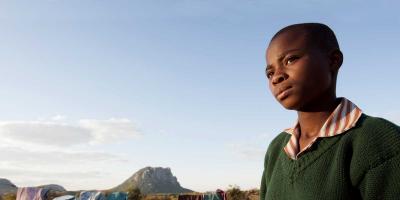 Takudza standing outside looking serious