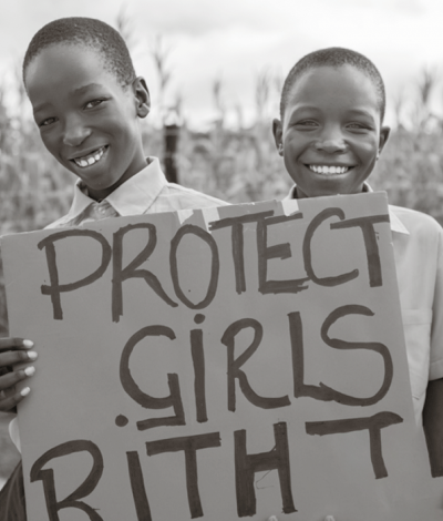 Two smiling boys with sign for child rights.