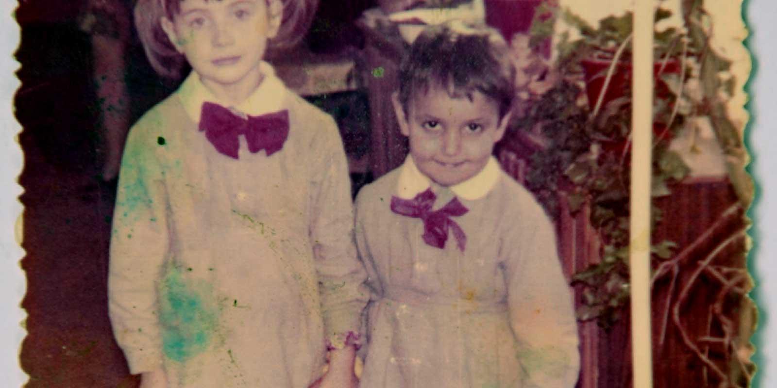 Valeriu as a boy, holding a girls hand.