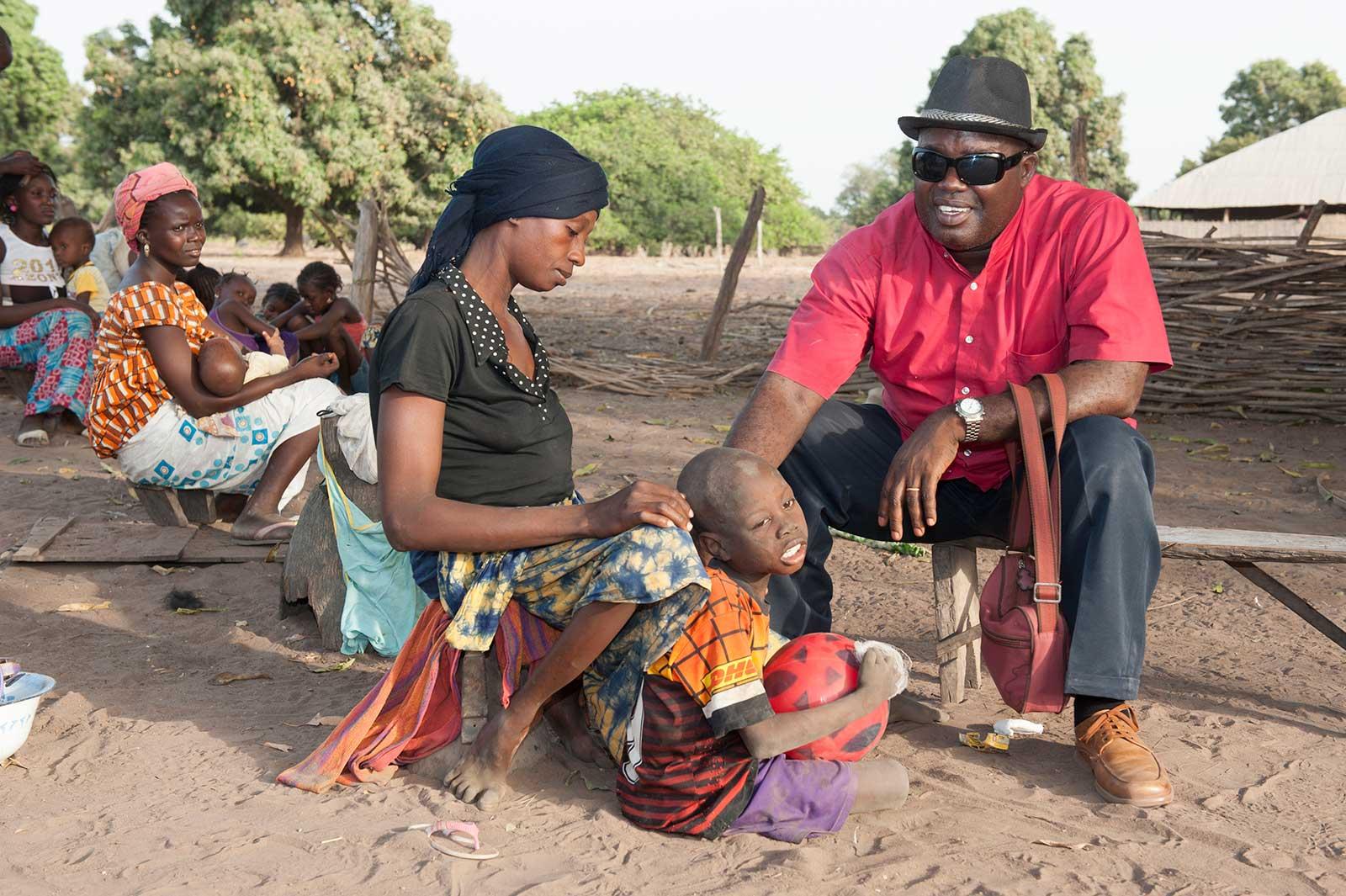 Manuel talks to woman with child